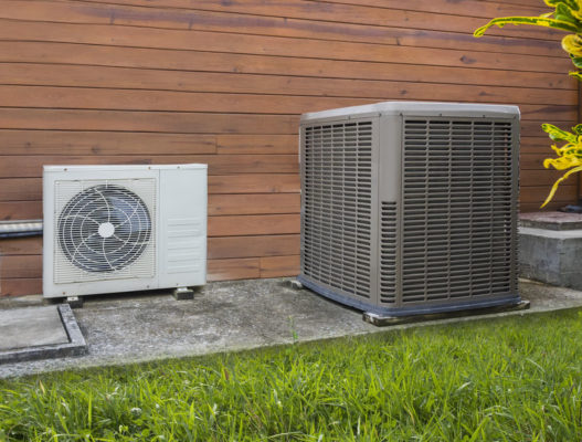outdoor traditional unit and outdoor compressor unit to ductless sitting outside of home